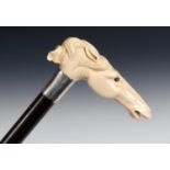 A 19th century walking stick, with a carved ivory handle in the form of a horse, with glass eyes, in