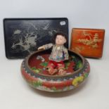 An early 20th century Chinese doll, in silk robes, worn, 23 cm high, a cloisonné bowl, dented, 30 cm