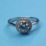 An 18ct white gold and halo set diamond ring, ring size N½ Diamond is 6.2mm x 6.2mm approx. cannot