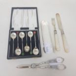 A pair of silver grape scissors, a set of six silver coffee spoons, with bean finials, boxed, and