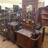 A 19th century mahogany bow front washstand, four others, an oak armchair, a carved two tier