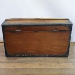 A 19th century dome top camphorwood trunk, with brass and leather mounts, central plaque