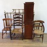 An early 20th century walnut pot cupboard, another, three chairs, an oval mirror, and a brass