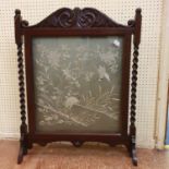 A Japanese needlework panel, decorated a heron, 52 x 54 cm, set in an oak fire screen