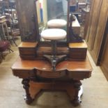 A 19th century mahogany dressing table, 120 cm wide and a 19th century rosewood piano stool (2)