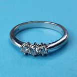 An 18ct white gold and three stone diamond ring, ring size O