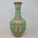 A Chinese green ground vase, with horizontal bands of floral decoration, character mark to base,
