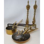 A pair of brass and cast iron fire dogs, two sets of graduated brass pans, various metalwares and