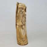 An early 20th century Chinese ivory tusk, carved in the form of Shou Lao, 28 cm high