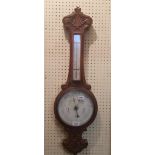 A late 19th century barometer and thermometer, in a carved oak case, 82 cm high