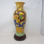 A Chinese pottery vase, of inverted baluster form, decorated brown, green and blue dragons chasing