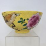A Chinese yellow ground bowl, decorated with flowers and birds, four character mark to base, 15 cm