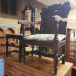 A 17th century style oak armchair, with carved top rail dated 1636, on turned tapering legs and an