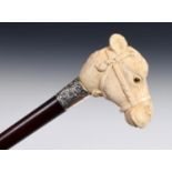 A 19th century walking stick, with carved ivory handle, form of a camel, with silver mount on