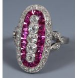 A platinum, ruby and diamond elongated ring, ring size M