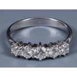 An 18ct white gold and five stone graduated diamond ring, ring size L Central stone 4.54mm wide 2.51
