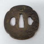 A Japanese pierced bronze tsuba, 6 cm wide