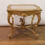 A 19th century rococo style gilt gesso and carved wood serpentine table, on scroll legs united by an