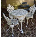 A Victorian style painted cast metal garden table, three matching chairs, table and a plant stand (