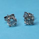 A pair of white gold and diamond stud earrings 4.4 mm diameter approx. Clear stones no obvious