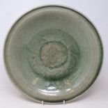 A Chinese celadon bowl, decorated with lotus flower, 36 cm diameter Large crack to centre see
