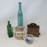 An Eastern brass oil lamp, converted to electricity, various green glass bottles, a Mason's