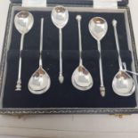 A set of six silver coffee spoons, with seal and knot tops, London 1963, cased, three silver