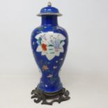 A Chinese famille rose vase and cover, of inverted baluster form, decorated panels of figures on a
