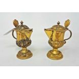 A pair of 17th century style gilt metal ewers, with embossed decoration, 11 cm high (2)