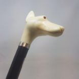 A walking stick, with a faux ivory handle in the form of a dog, on an ebonised shaft, 91 cm