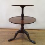 A 19th century mahogany two tier dumb waiter, on a tripod base, 85 cm high