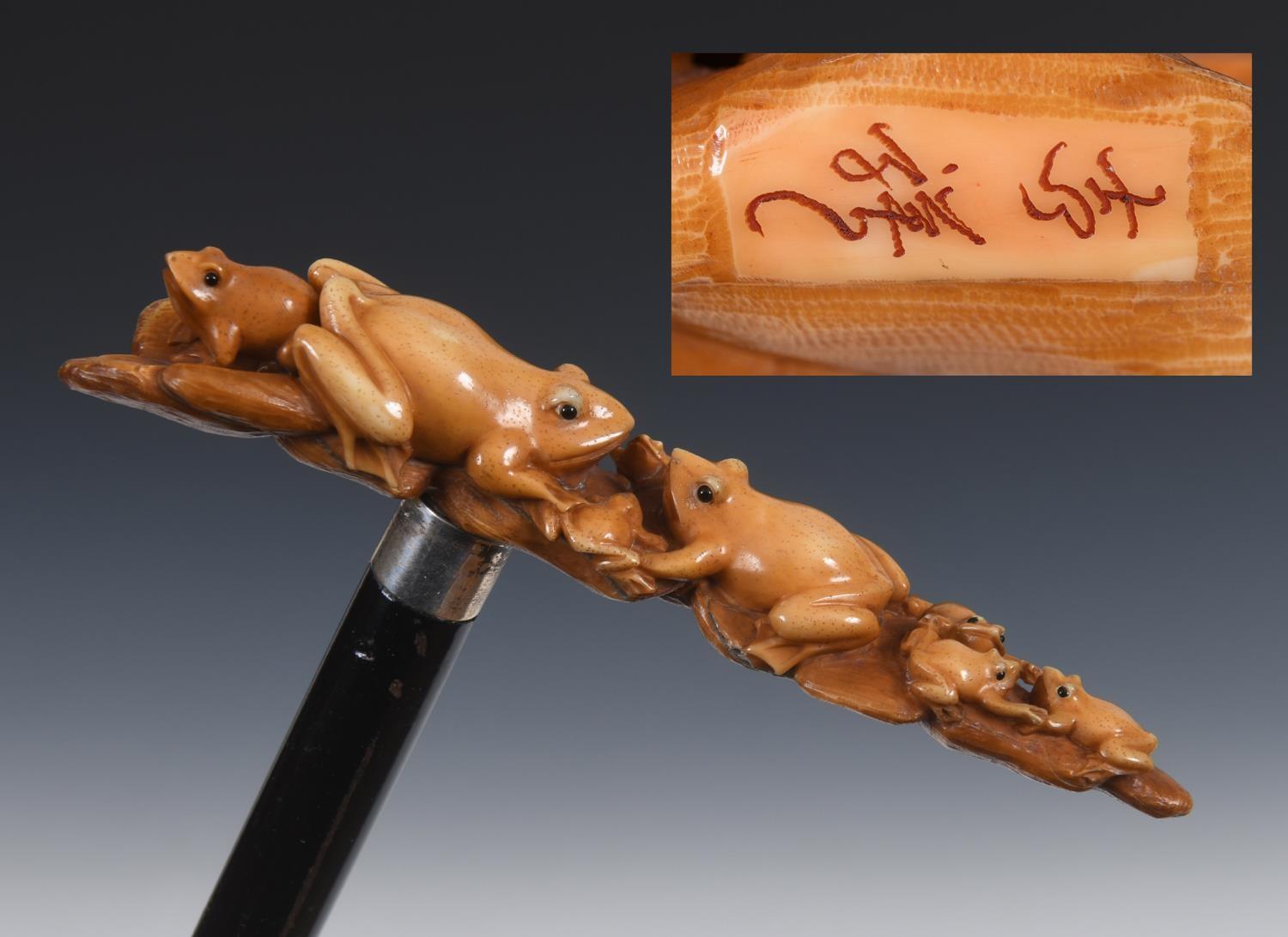 A 19th century walking stick, with a Japanese carved ivory handle in the form of six frogs, on an