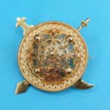 An Eastern yellow metal filigree brooch, in the form of a shield and two swords Report by JS