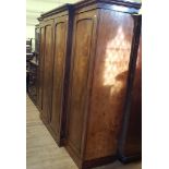 A 19th century mahogany breakfront wardrobe, with two central paneled doors revealing slides and