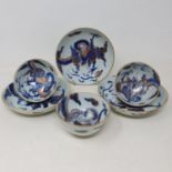 A set of three Chinese porcelain tea bowls and saucers, decorated dragons in underglaze blue, one