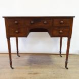 A 19th century mahogany kneehole table, with five drawers, on turned tapering legs, 99 cm wide