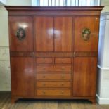 An early 20th century satinwood compactum, with painted decoration, the central section with two