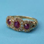 An 18ct gold and triple ruby cluster ring, ring size M½