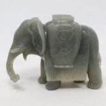 A Chinese green stone brush holder, in the form of an elephant, 14 cm wide Small chips on exposed
