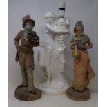 A pair of early 20th century Continental bisque figures, of a man and a woman, 38 cm high, and a