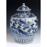 A Chinese vase and cover, with four face masks to the shoulder, the sides decorated exotic birds,