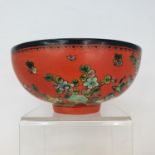 A Chinese red ground bowl, decorated birds, flowers and script, six character mark to base, 14 cm