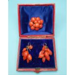 A pair of carved coral fruit drop earrings, slight loss/damage, in a fitted case, and a similar