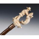 A late 19th century walking stick, with a carved ivory handle depicting a Boer soldier strangling