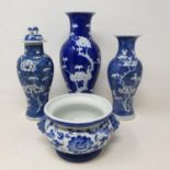 A Chinese blue and white vase, decorated with blossom, 26 cm high, and three others (4) These are