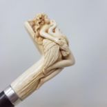 An Early 20th century walking stick, with carved ivory handle in the from of Leda and the Swan, on a