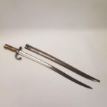 A French sword bayonet with a brass handle, engraved blade dated,1874 ,and scabbard, 71 cm