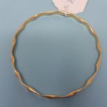 A 9ct gold bangle, 12.4 g 68mm x 70mm approx. JS
