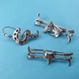 Three modern silver coloured metal tie pins, decorated a horseshoe, a fox head, and a horse head