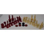 A 19th century red stained and natural ivory chess set, the King 10 cm high Pawns 39 mm high, king